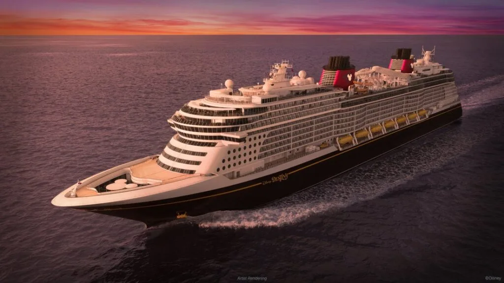 View of a Disney Cruise Ship sailing on the ocean at sunset