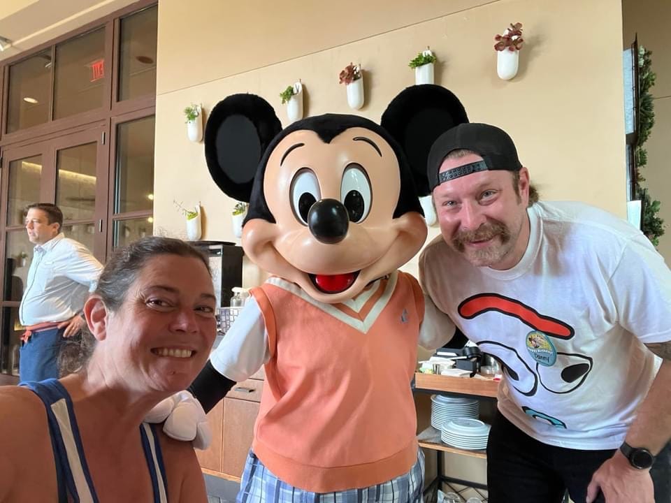A couple with Mickey Mouse at Ravello Character Dining Breakfast Walt Disney World