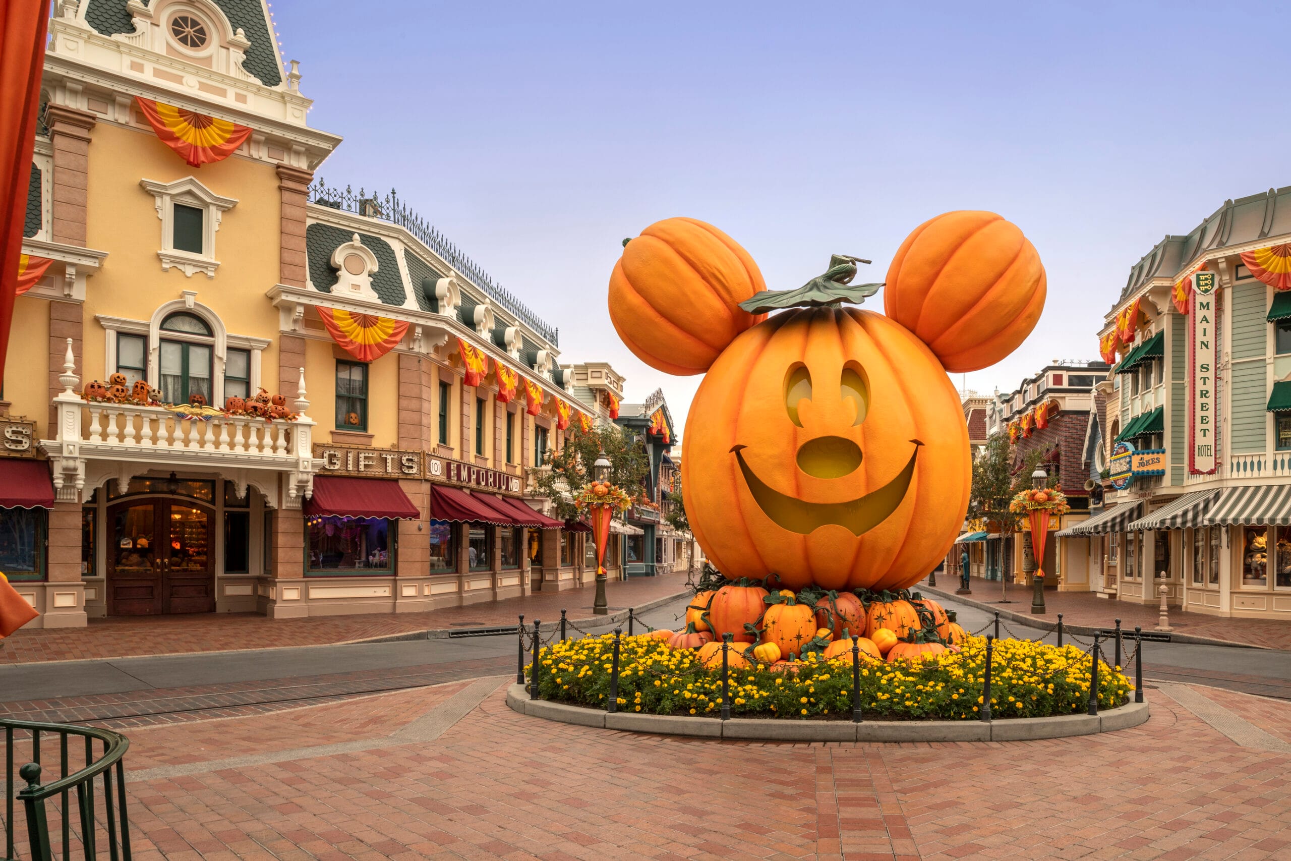 Halloween decorations and a giant jack-o-lantern on Main Street, Disneyland during the day