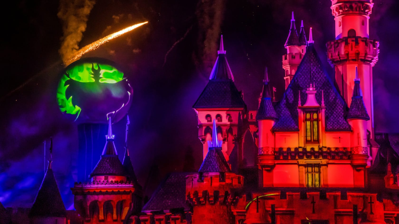 Sleeping Beauty's castle and a Halloween light and firework show