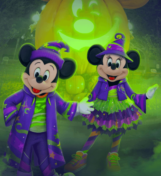 Mickey Mouse and Minnie Mouse in Halloween sorcerers' outfits in front of Halloween decorations